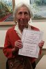 Elizabeth Karpati shows off her Good Citizen's Award from the FSPP in honor of her many years of service to the organization as Secretary, member of the Beautification Committee, and volunteer in, and advocate for Spy Pond Park.