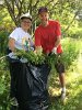 It was a family affair with Doris Birmingham and her son, Geoff, loading invasive plants into a bag in one of the planting beds in Spy Pond Park